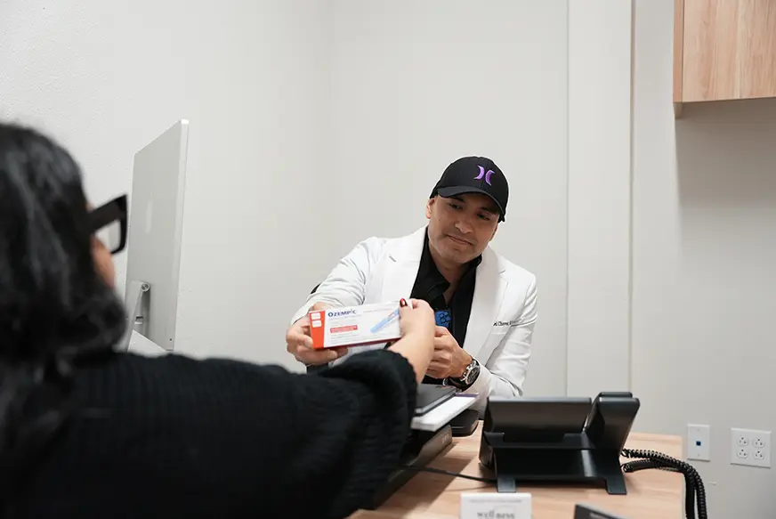 Provider reviewing a GLP-1 weight-loss prescription option with a client at KM Wellness Center in El Paso